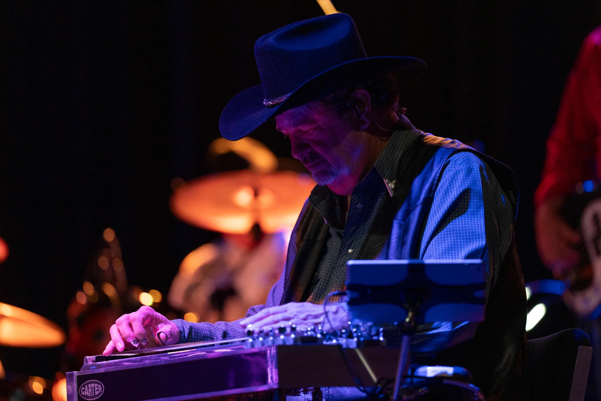 Steel guitarist focused on his instrument during the set