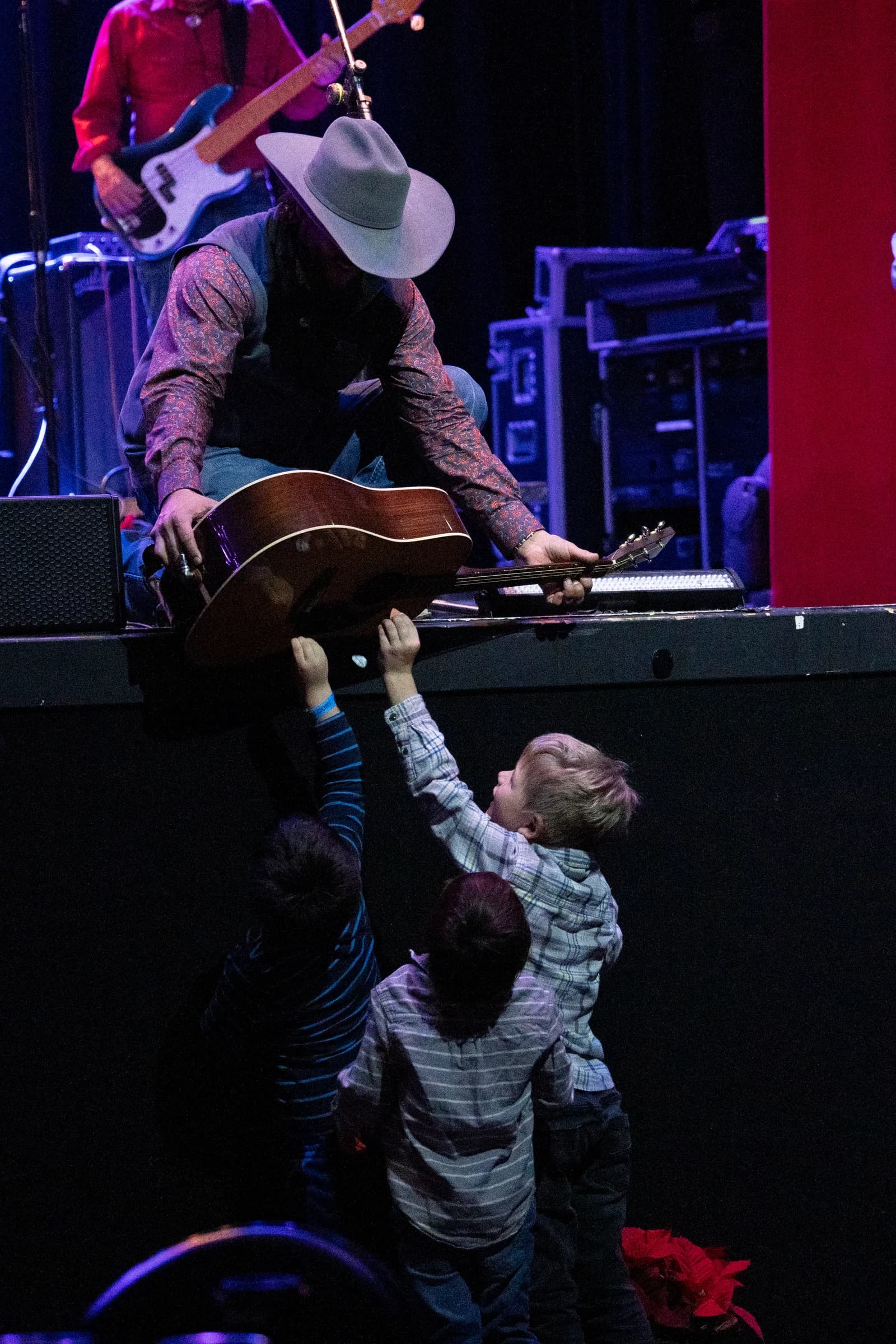 Buck Ford with his guitar at the edge of the stage