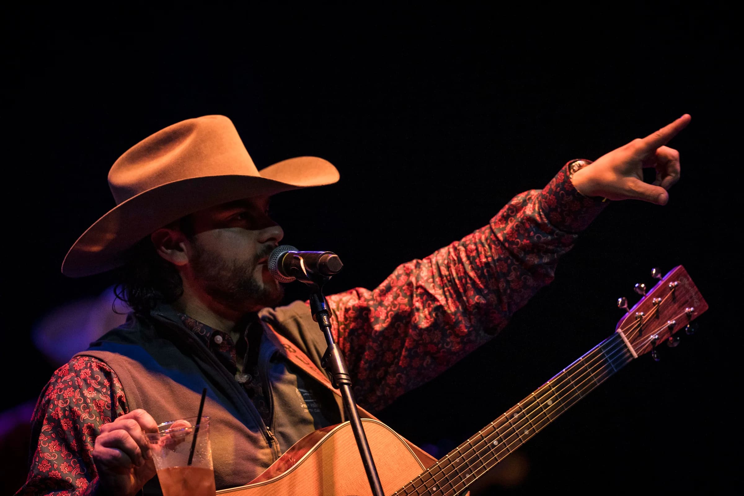 Buck Ford pointing out into the audience during a performance