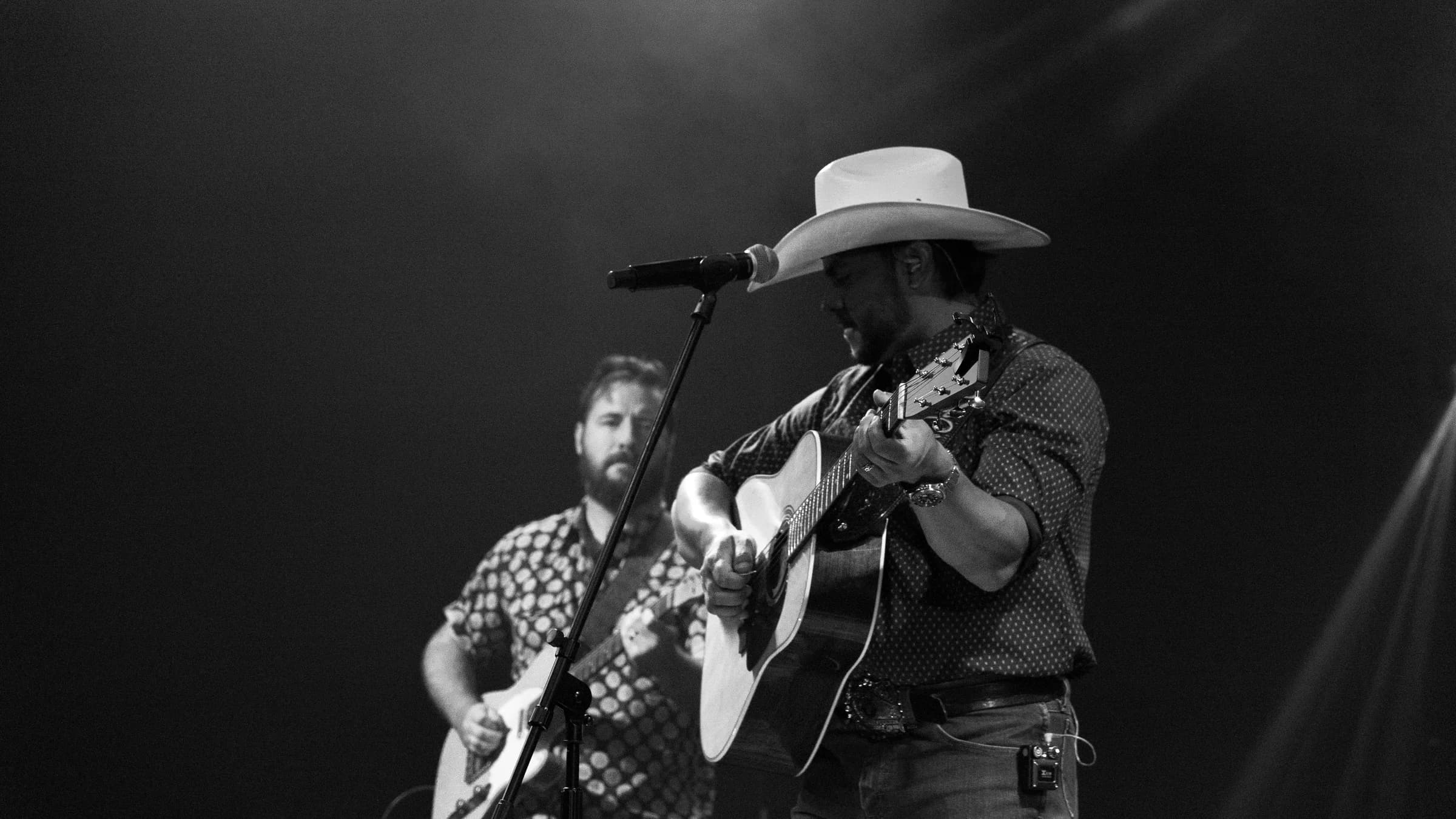 Buck Ford and a bandmate on stage in black and white