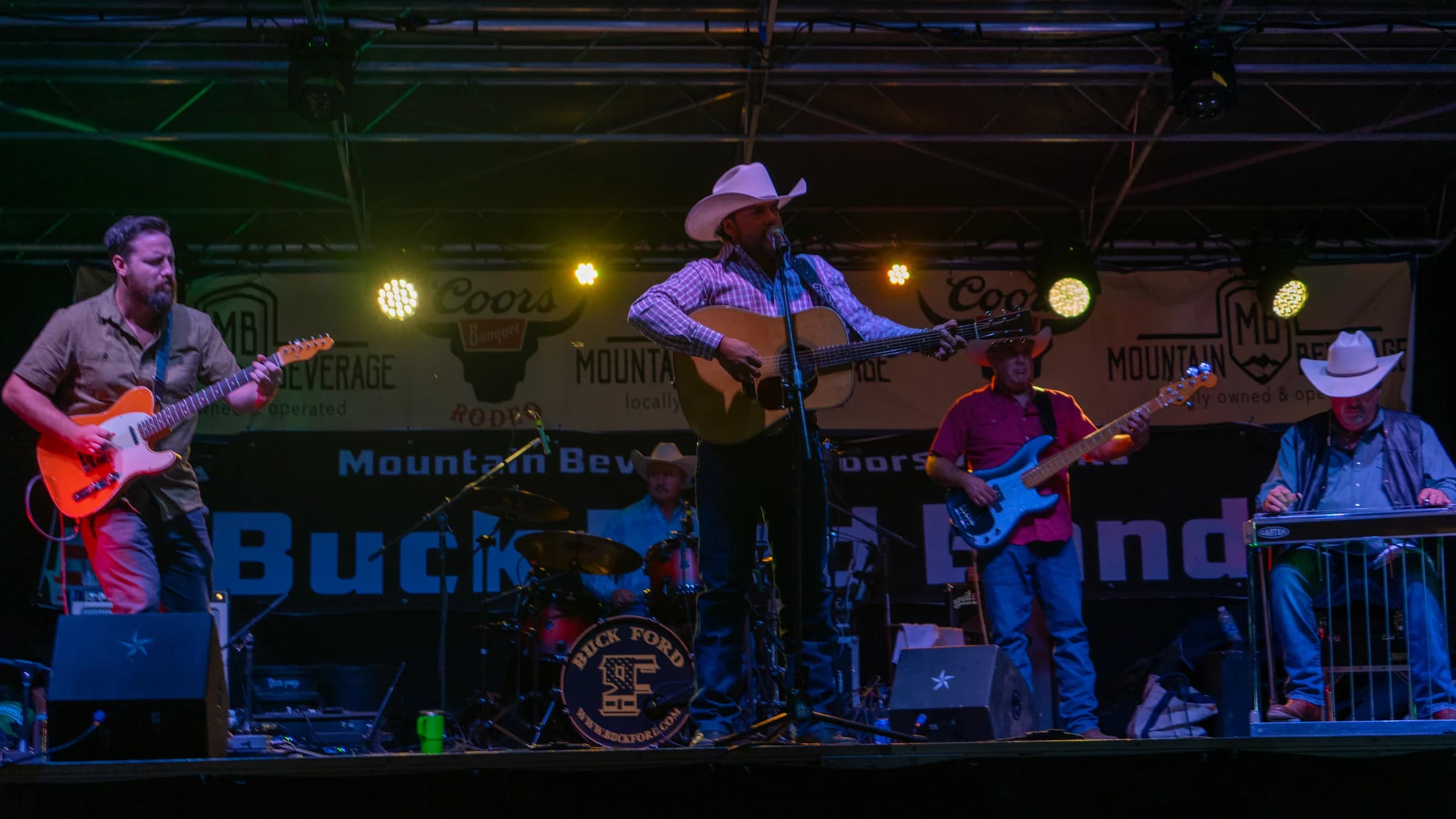 Buck Ford and the band on an outdoor stage