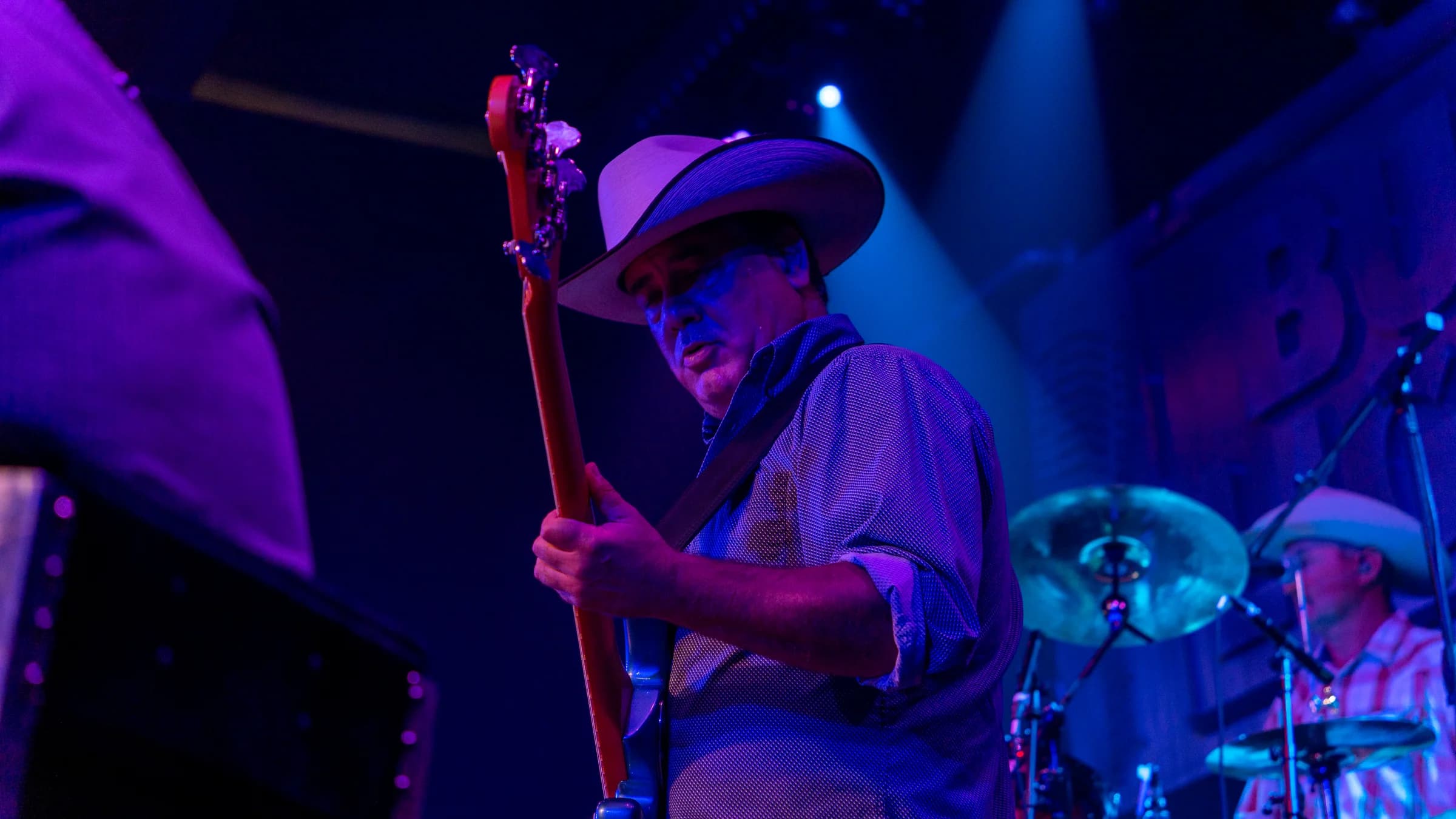 Buck Ford leaning toward his guitar during a live performance